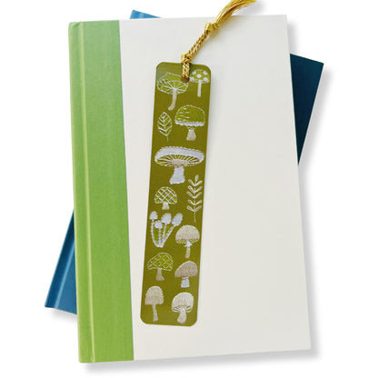 1.5x7 inch bookmark with assorted mushrooms embroidered on a light green background by Rikrack