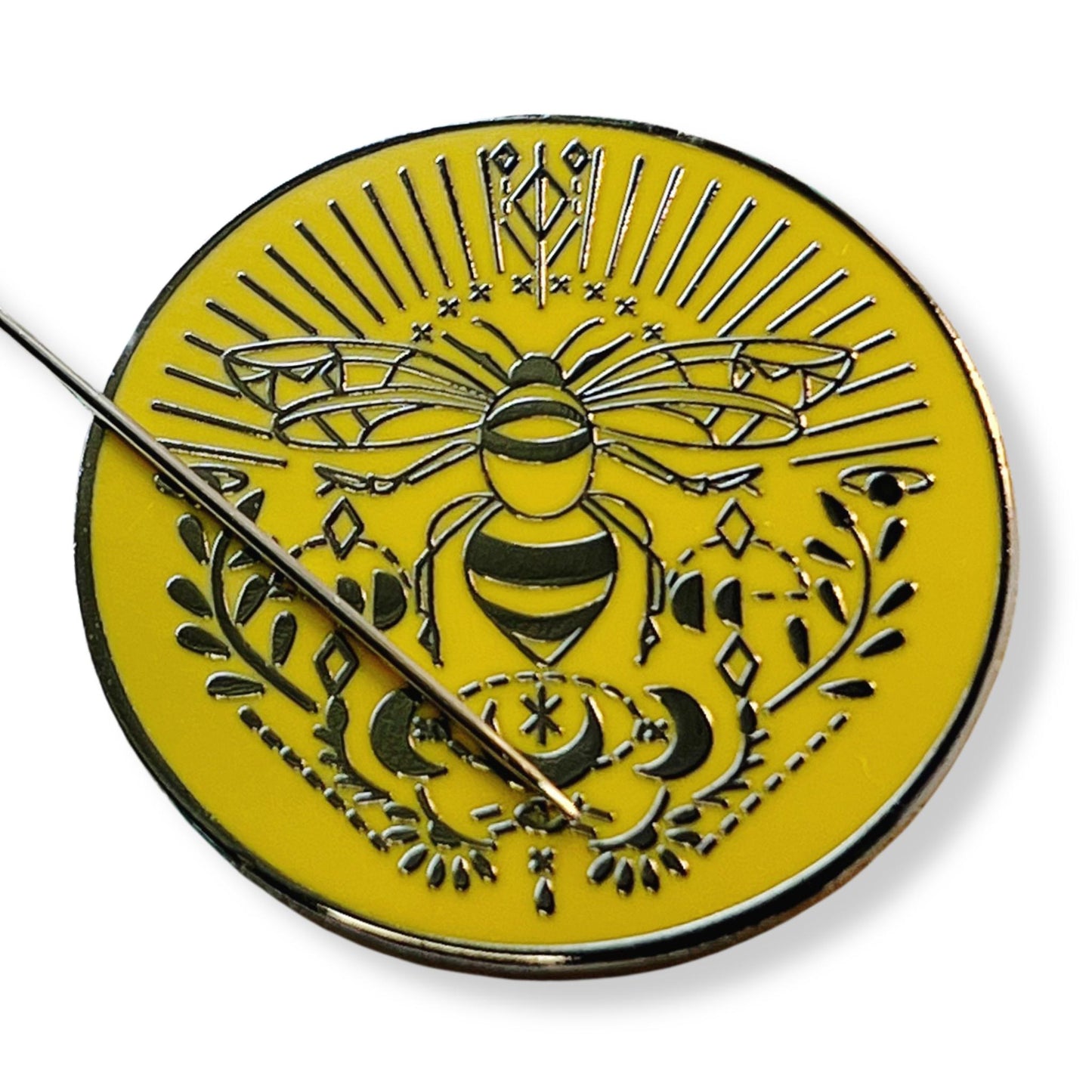 magnetic needle minder with bee design on a yellow enamel background