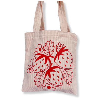 light pink corduroy tote bag with red strawberry silkscreened design