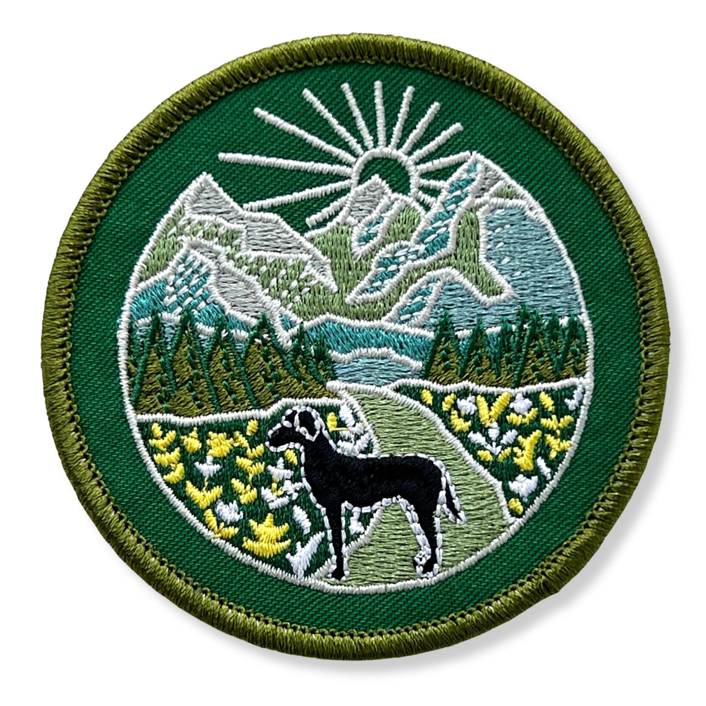 embroidered patch with sticker back green and blue mountain scene with black dog