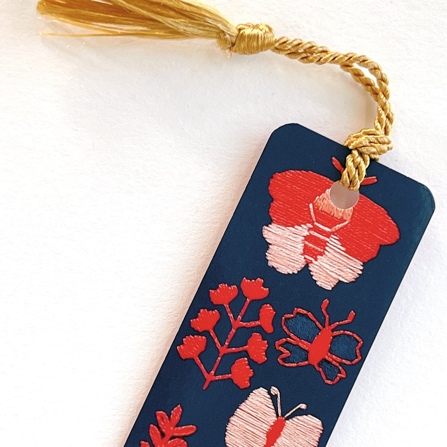 Gold tassel on Dark blue bookmark with pink and red embroidered butterflies by Rikrack